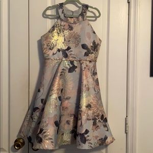 An A-line dress with metallic floral details.